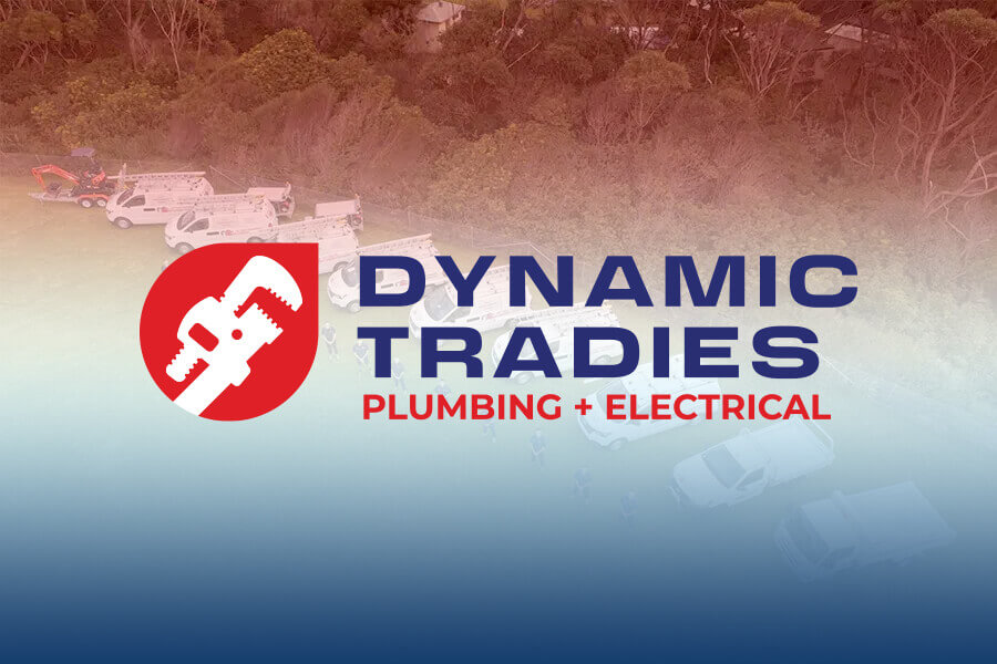Dynamic-Tradies-Plumbing-and-Electrical-logo-over-a-background-of-work-vehicles-and-trees